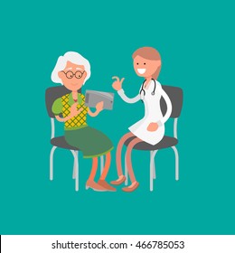 Cheerful female doctor talking with old lady holding tablet. Medical Consultation between doctor and her patient at clinic.