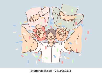 Cheerful friends take selfie together at party in nightclub, posing among falling confetti. Student party with man and two women enjoying fun atmosphere and taking photo as souvenir