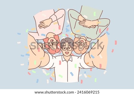 Cheerful friends take selfie together at party in nightclub, posing among falling confetti. Student party with man and two women enjoying fun atmosphere and taking photo as souvenir
