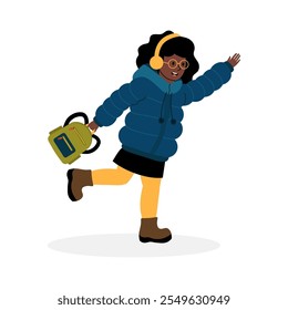 Cheerful girl celebrating winter with a bell and cozy clothing in a festive mood