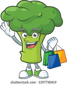 Cheerful green broccoli mascot waving and holding Shopping bags