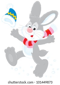 Cheerful grey rabbit with a cap and scarf
