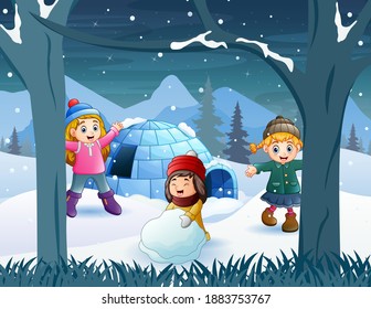 Cheerful kids playing a snow near the igloo house