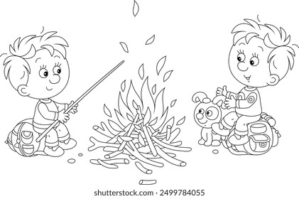 Cheerful little boys tourists with a merry pup resting in their camp and talking by a campfire, black and white outline vector cartoon illustration for a coloring book page