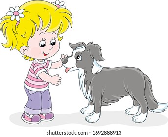 Cheerful little girl walking and playing with a small border collie, vector cartoon illustration on a white background