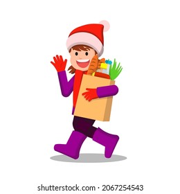 Cheerful little girl in winter clothes carrying groceries