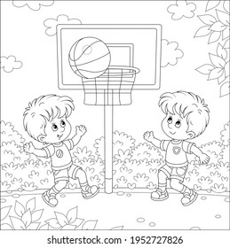 Cheerful Little Kids Playing Basketball With A Big Ball On A Sports Ground In A Park On Summer Vacations, Black And White Vector Cartoon Illustration For A Coloring Book Page