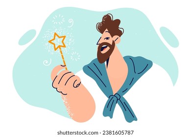 Cheerful man with magic card in hand encourages to make wishes and believe in miracles. Guy with fairy magic wand smiles, wanting to create magical miracle and get into fairy tale.