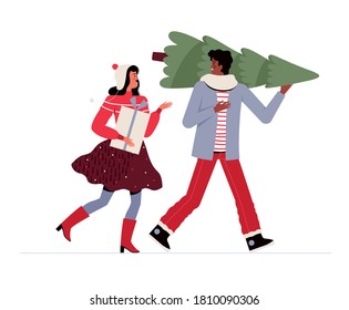 Cheerful man and woman in festive clothes carry a Christmas tree and a gift and communicate. People are preparing for Christmas