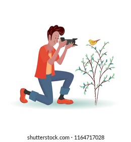 Cheerful man-photographer is taking pictures of a bird sitting on a bush. Vector isolated illustration with texture in cartoon style.