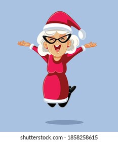 Cheerful Mrs Claus Jumping with Excitement. Senior woman feeling joyful celebrating winter holidays
