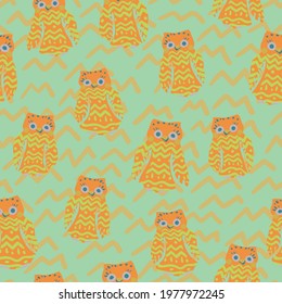 cheerful orange owls vector pattern on green