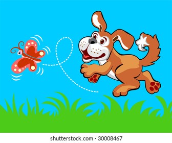 The cheerful puppy plays with the butterfly