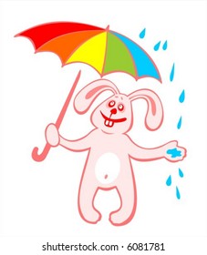The cheerful rabbit with a umbrella catches rain drops.
