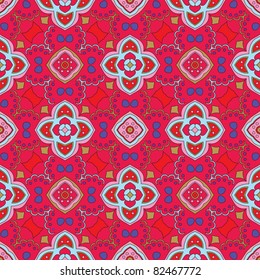 Cheerful, seamless and colorful floral pattern with swirls on a bright red background