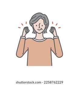 A cheerful senior woman doing a fist pump with a smile
