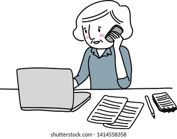 Cheerful senior woman using computer and talking on the phone at her desk. Cute businesswoman talking on the phone while looking at laptop screen. Mature woman working efficiently in the workplace.