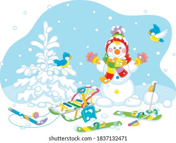 Cheerful small birds flying around a smiling cute toy snowman with a warm colorful scarf and a hat, skis and a sledge on a snowy playground in a white winter park, vector cartoon illustration