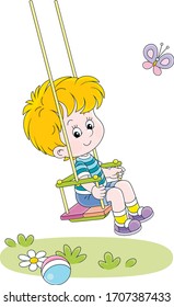 Cheerful small boy swinging on a summer playground in a park, vector cartoon illustration on a white background