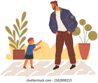 Cheerful smiling laughing father and son walking together outdoors, man talking to little boy. Child stretched out his hands forward asks dad to take him in arms. Happy family child care and parenting
