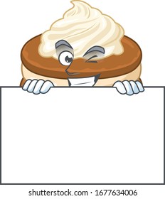 Cheerful white cream alfajor cartoon character has a board