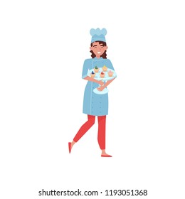 Cheerful woman holding glass cake stand with delicious cupcakes. Baker in uniform and hat. Flat vector design