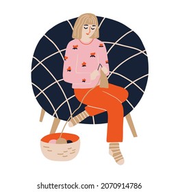 Cheerful woman is sitting in pajamas and socks in armchair and knitting. Yarn in basket and girl in cozy armchair. Vector illustration in modern flat style isolated on white background