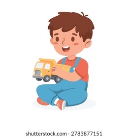 Cheerful Young Boy Sitting on Floor Holding Yellow Toy Truck in Casual Outfit
