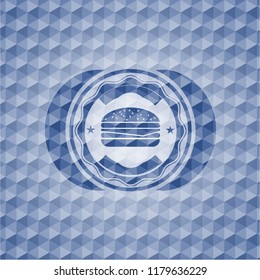 cheeseburger icon inside blue emblem with geometric background.
