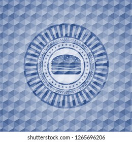 cheeseburger icon inside blue emblem or badge with abstract geometric polygonal pattern background.