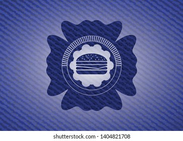 cheeseburger icon inside emblem with denim texture