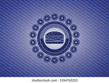 cheeseburger icon inside emblem with denim texture