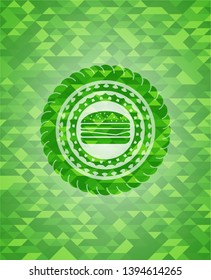 cheeseburger icon inside green mosaic emblem