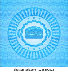 cheeseburger icon inside light blue water wave badge.