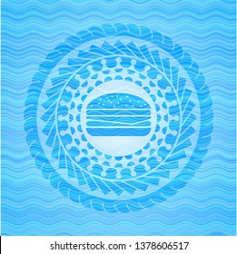 cheeseburger icon inside light blue water wave emblem.