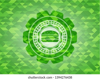 cheeseburger icon inside realistic green emblem. Mosaic background