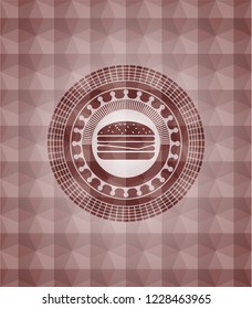 cheeseburger icon inside red seamless emblem with geometric background.