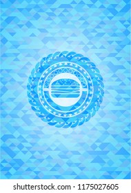 cheeseburger icon inside sky blue emblem. Mosaic background
