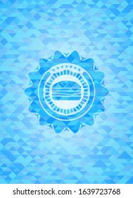 cheeseburger icon inside sky blue emblem. Mosaic background