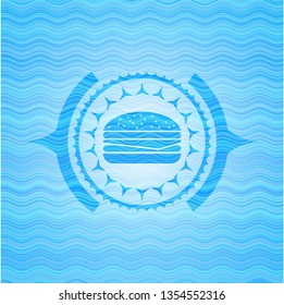 cheeseburger icon inside water wave style emblem.