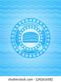 cheeseburger icon inside water wavec oncept emblem.