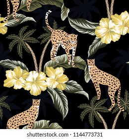 Cheetah, yellow hibiscus flowers and  tropical palm trees floral black background seamless pattern. Exotic wallpaper.