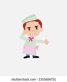 Chef , is angry and points his head with his index finger.