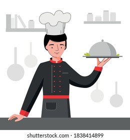 Chef con uniforme negro con bandeja de plata. Cocina del chef en la cocina.