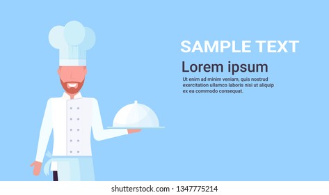 chef cook holding covered platter with dish man in uniform professional occupation food cooking concept male cartoon character portrait blue background horizontal copy space