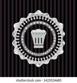 chef hat icon inside silvery emblem or badge