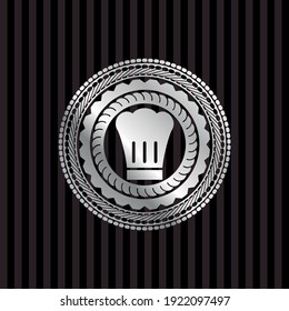 chef hat icon inside silvery emblem. 