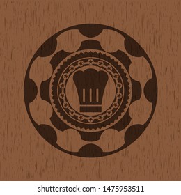 chef hat icon inside wooden emblem