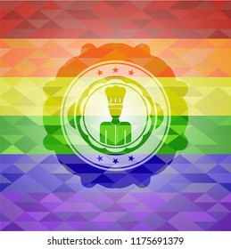 chef icon inside emblem on mosaic background with the colors of the LGBT flag