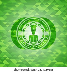 chef icon inside green emblem with triangle mosaic background
